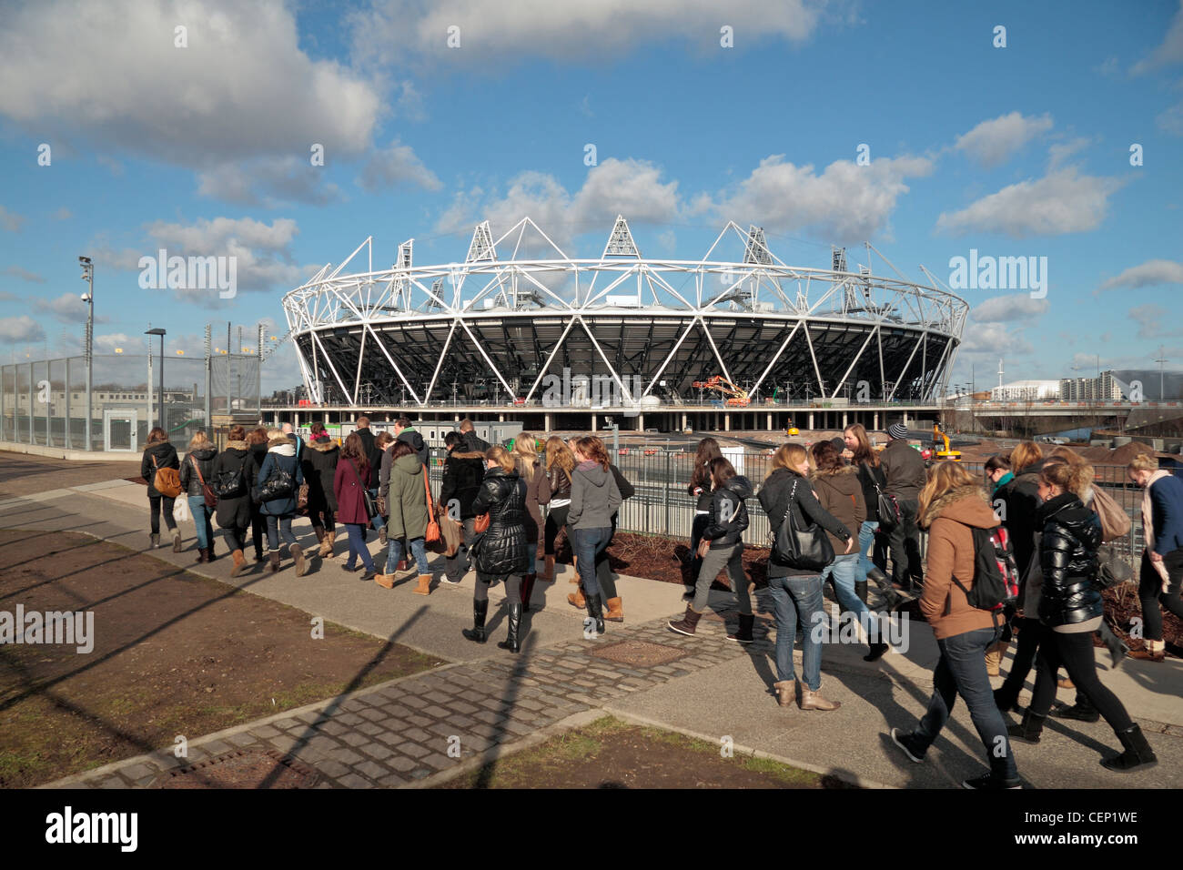 A tour group visiting the nearly complete (in Feb 2012) London 2012 Olympic Athletics Stadium in Stratford, London. Stock Photo