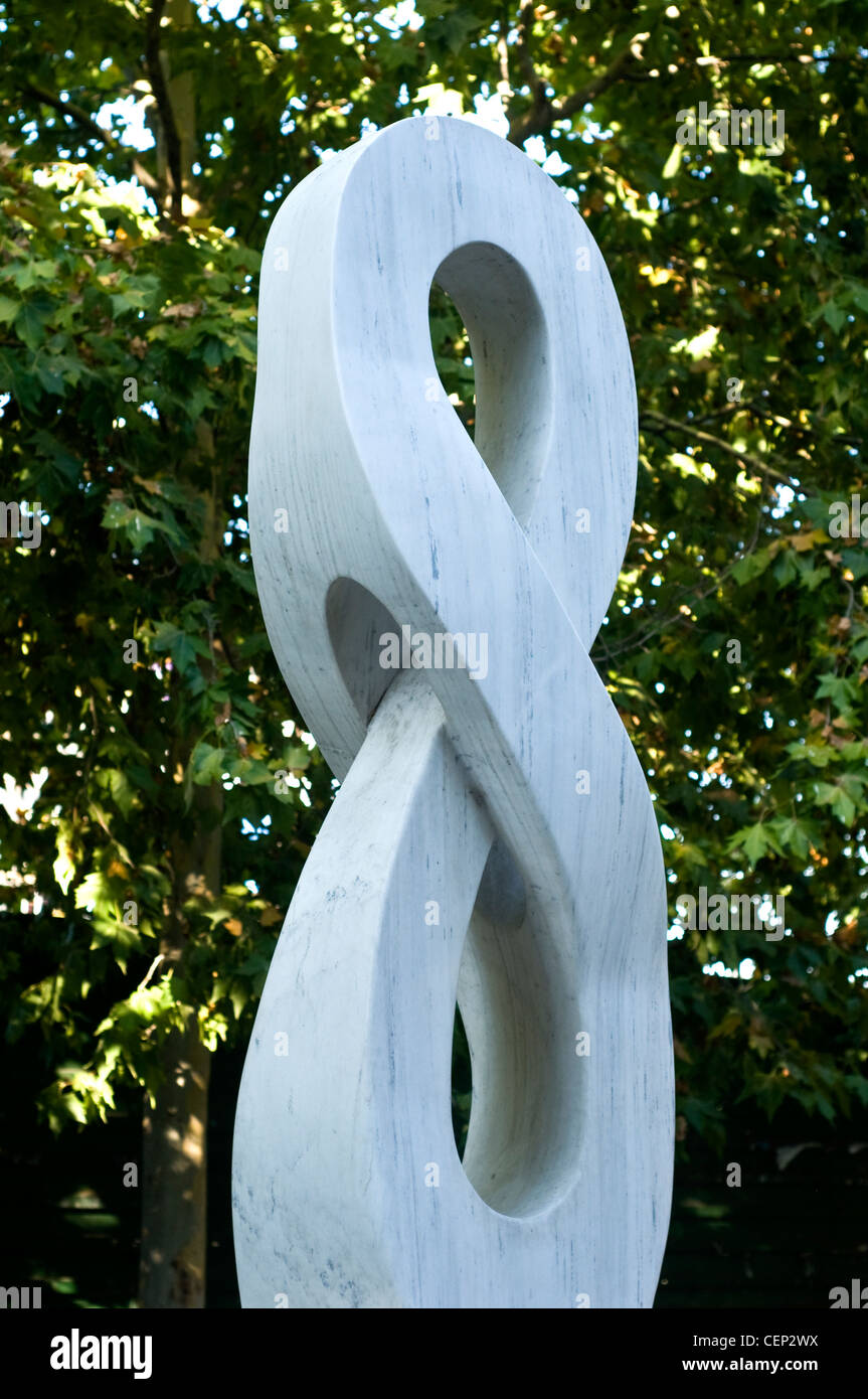 Abstract white stone sculpture surrounded by greenery in Ohrid. Modern ...