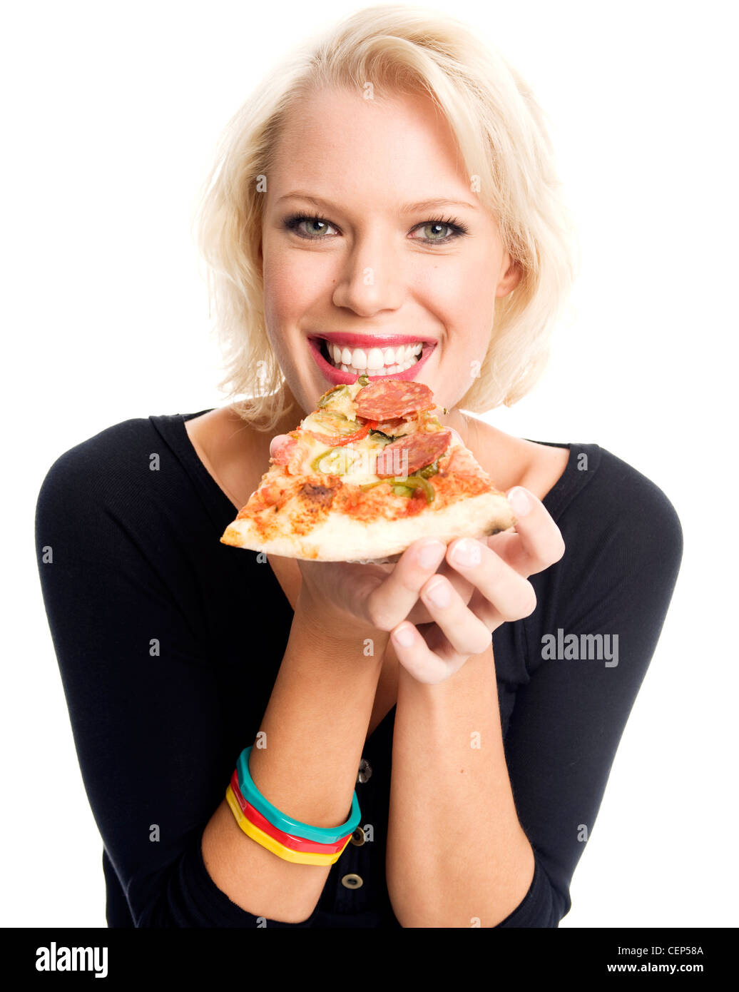 Female holding a slice of thin crust italian style pizza, about to take a bite Stock Photo