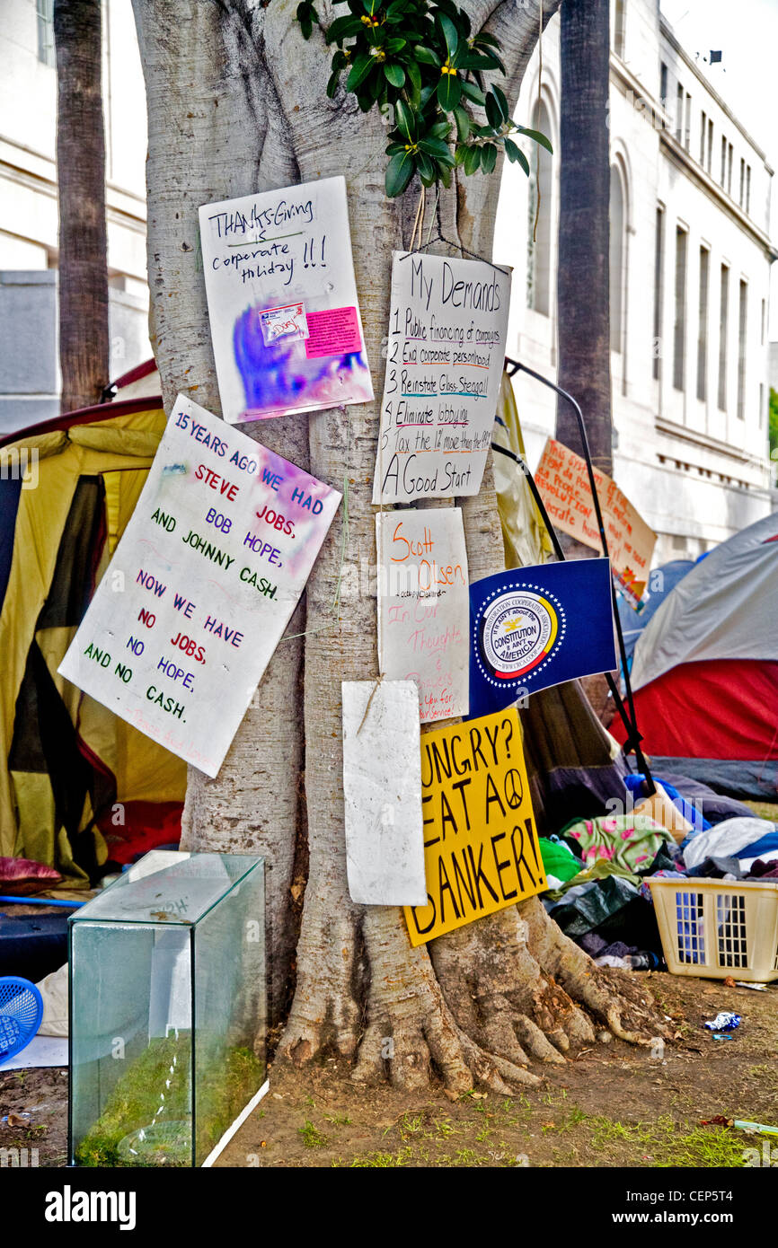 Signs express the anti-establishment opinions of young Occupy Wall Street protesters occupying Los Angeles city hall grounds. Stock Photo