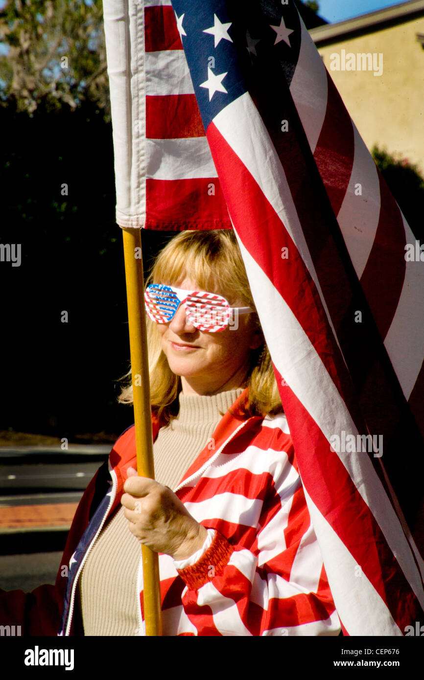 Dressed in patriotic stars and stripes and carrying an American flag, a political demonstrator makes a sartorial display. Stock Photo
