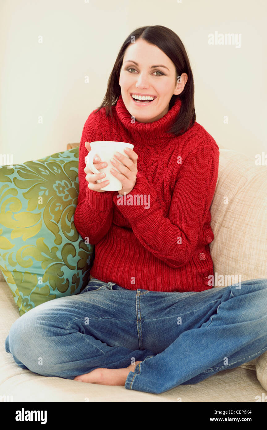 Female Short Brunette Hair Wearing Red Roll Neck Jumper And Jeans