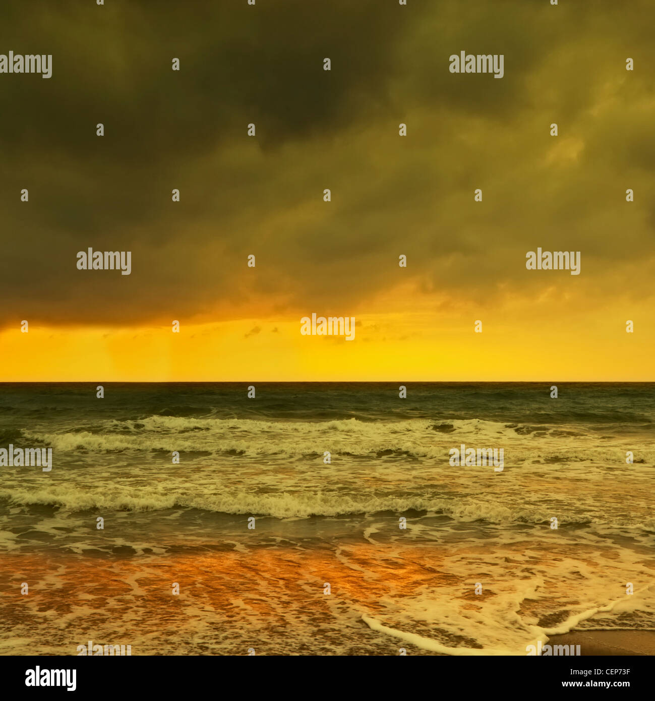 waves breaking on a wintery beach at dawn; spain Stock Photo