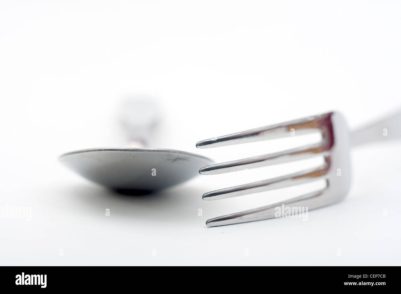 Silver fork and spoon over a white background Stock Photo