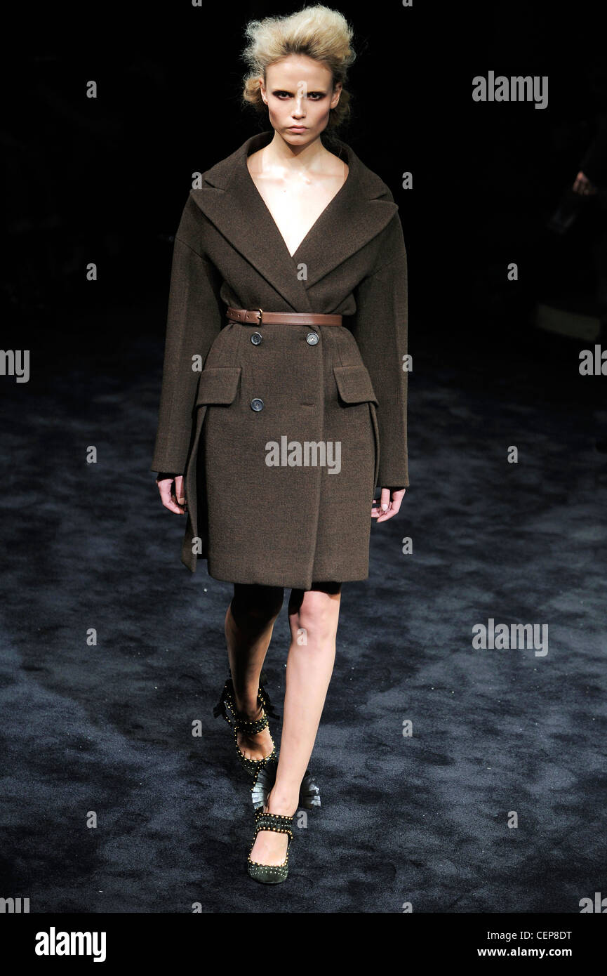 Prada Milan Ready to Wear Autumn Winter Model Natasha Poly wearing a knee length brown double breasted boiled wool coat brown Stock Photo