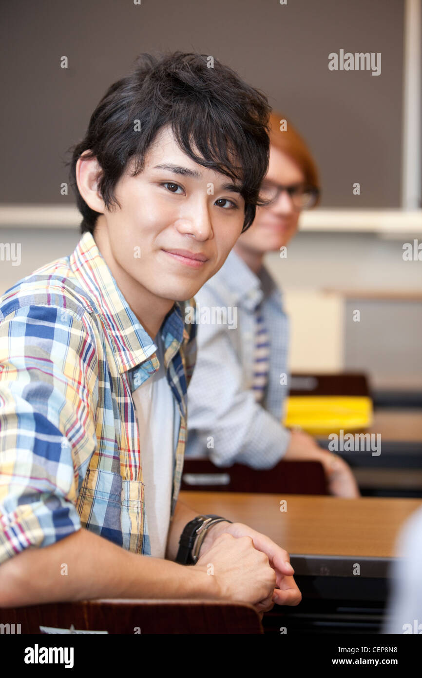 Young man smiling in classroom Stock Photo - Alamy