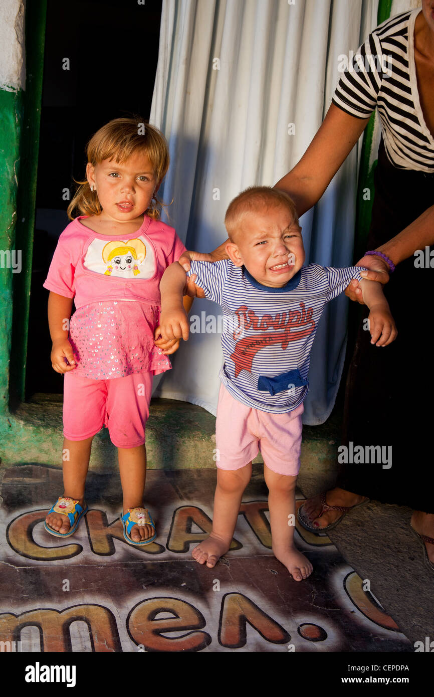 Crying Roma gypsy child in Bulgaria Stock Photo