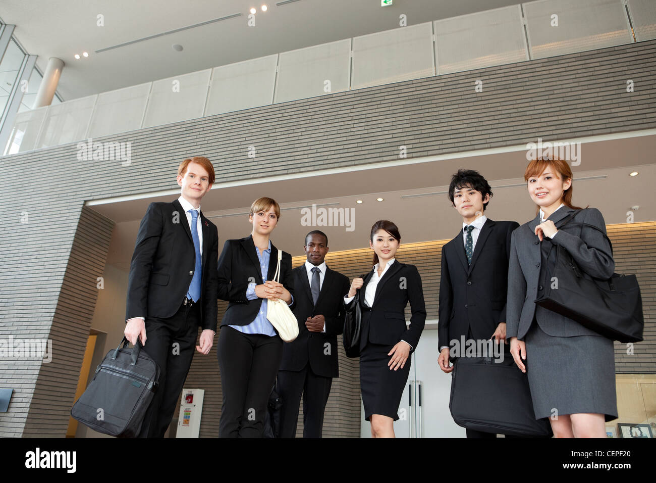 Businessmen and businesswomen standing side by side Stock Photo - Alamy