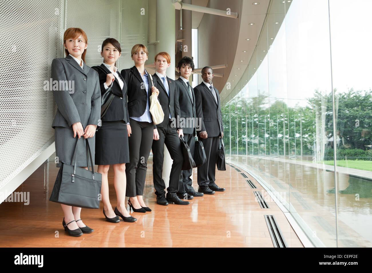 Businessmen and businesswomen standing side by side Stock Photo - Alamy
