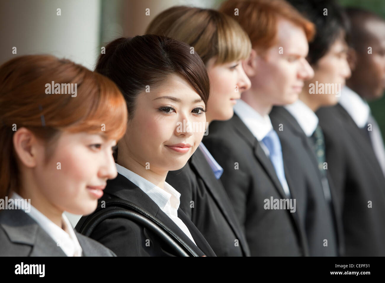 Businessmen and businesswomen standing side by side Stock Photo - Alamy