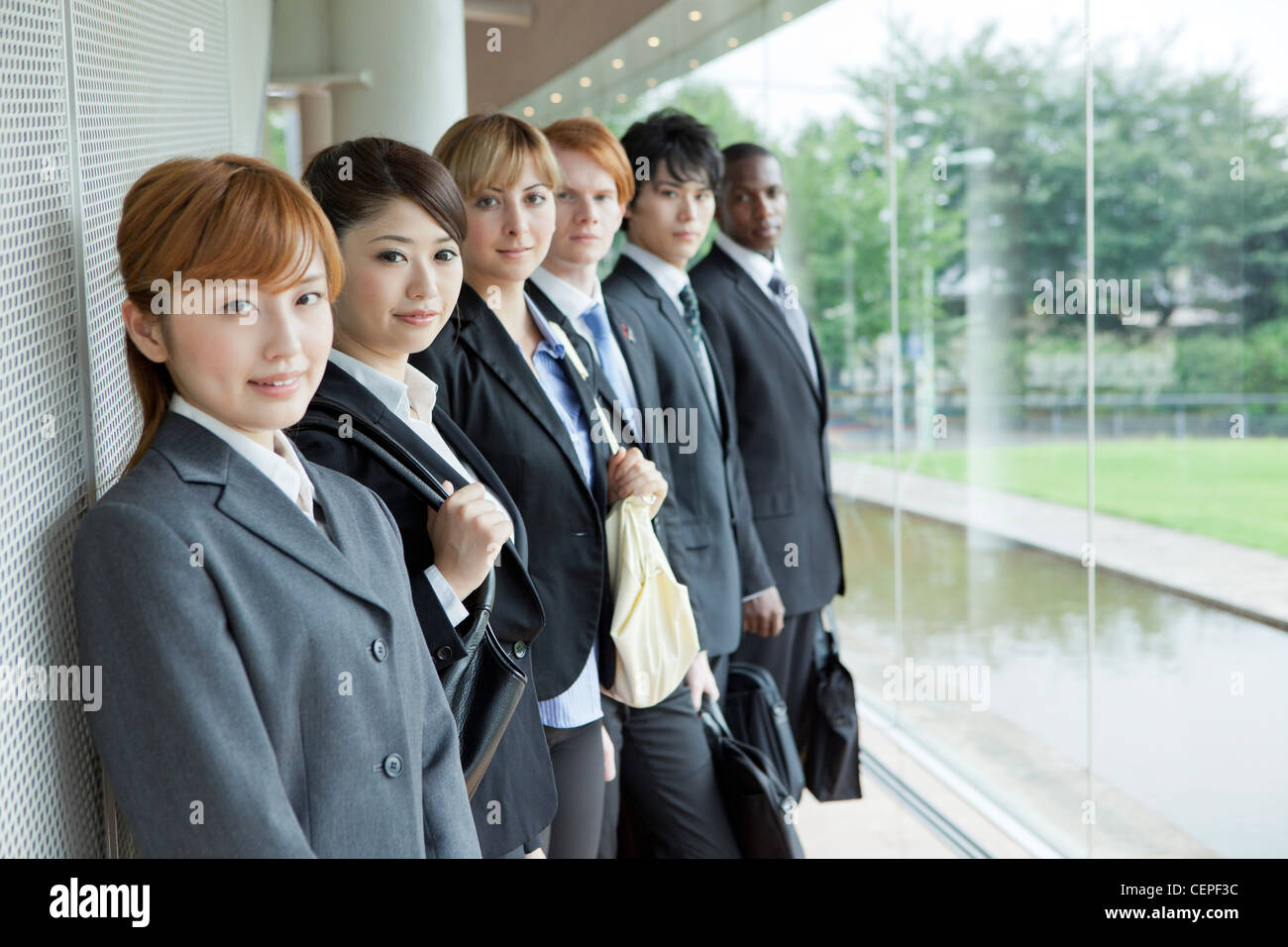 Businessmen and businesswomen standing side by side Stock Photo - Alamy