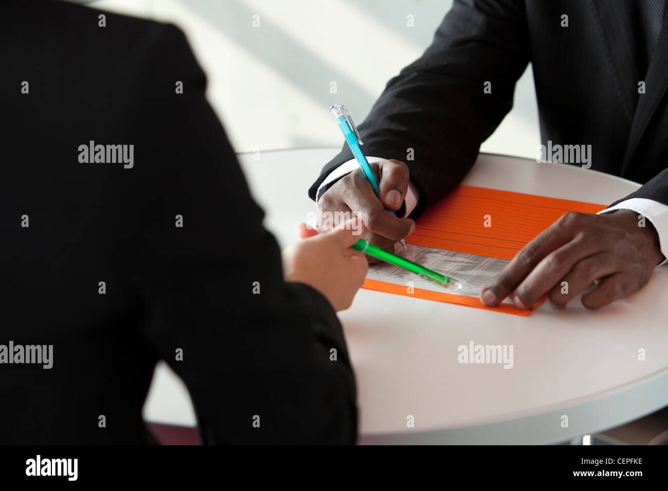 Businessman and businesswoman having meeting Stock Photo - Alamy