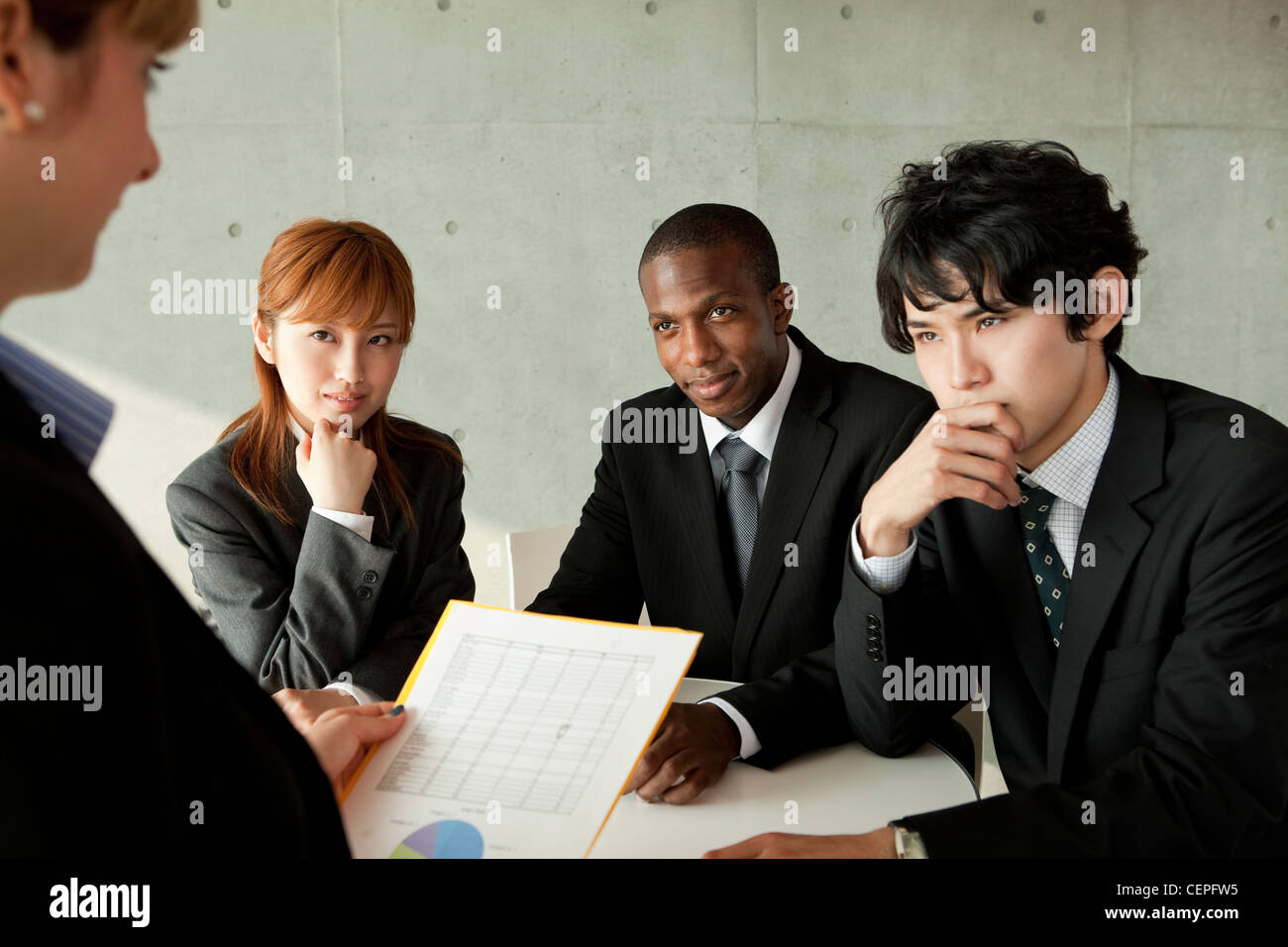 Businessmen and businesswomen having a meeting Stock Photo - Alamy