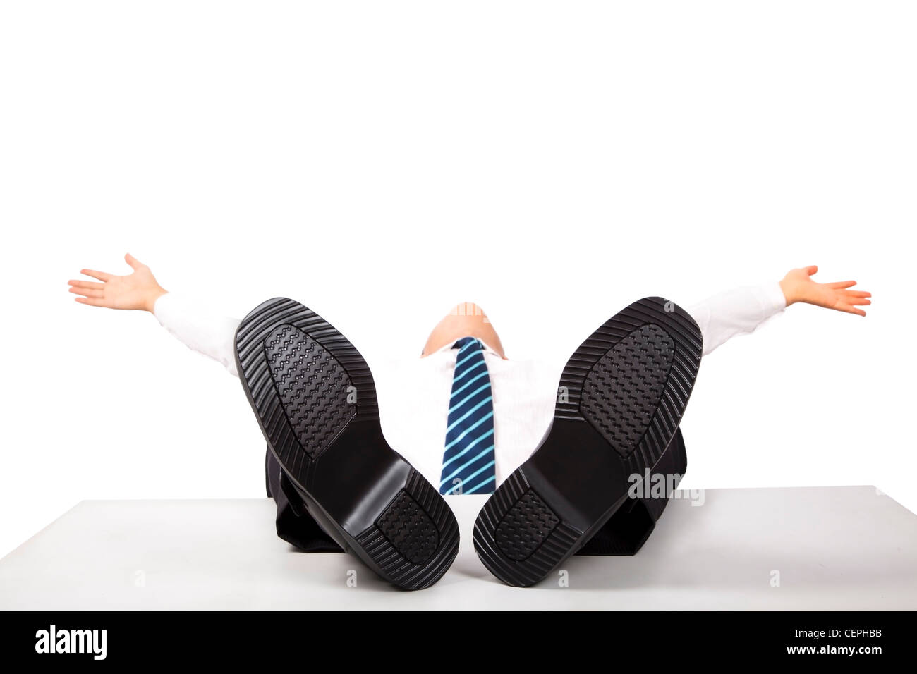 Relaxing business man with feet up on the desk Stock Photo