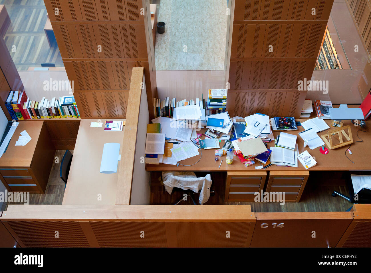 Two private reading/study rooms in a library. The contrasts of two different people can be seen, one untidy the other neat Stock Photo