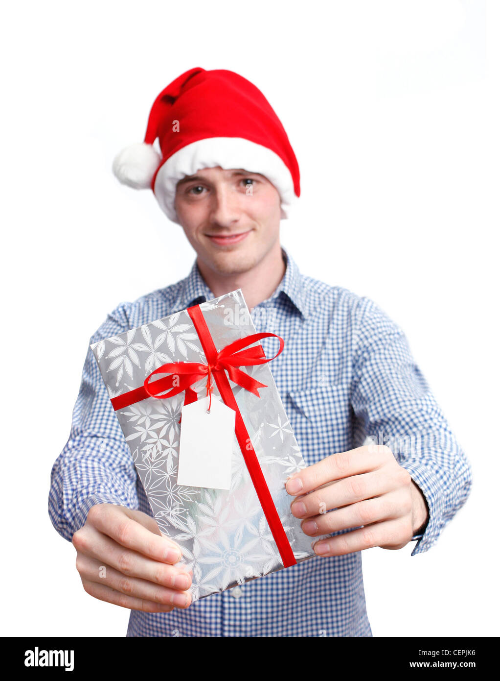 Man with santa hat holding christmas present Stock Photo
