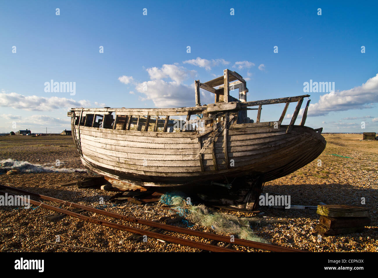 old and abandoned fishing boat on the beach in Dungeness in Kent Stock ...