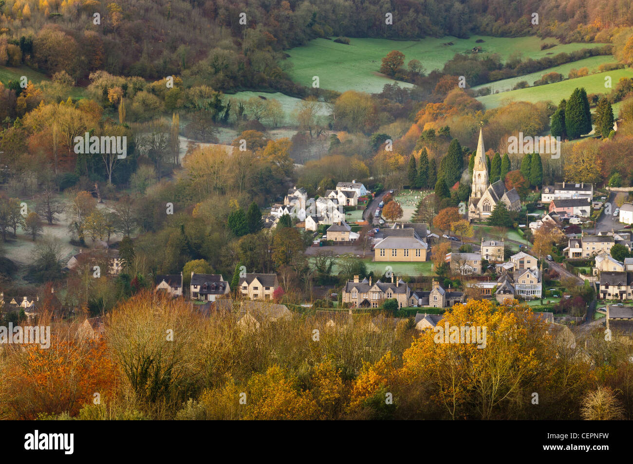 View across Nailsworth Valley towards Woodchester St Mary Church from Rodborough Common, early morning in autumn near Stroud Stock Photo