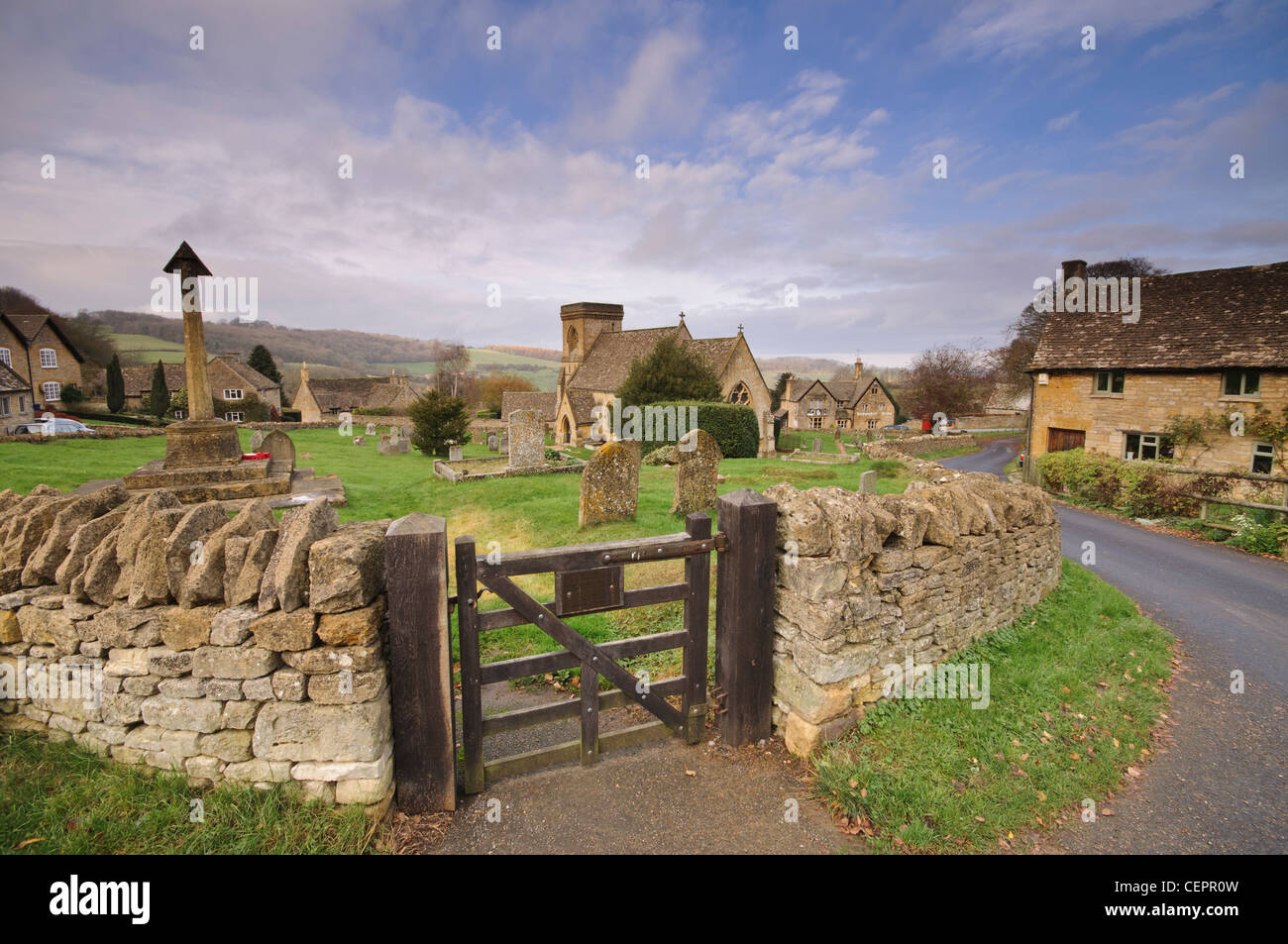 Cotswold stone cottages and St Barnabas Church in the village of Snowshill in Gloucestershire, UK Stock Photo