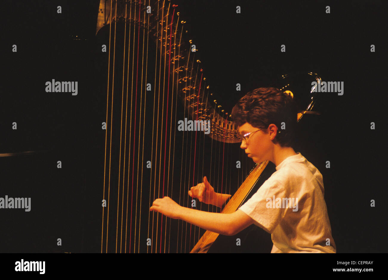 Strumming a harp Stock Photo Alamy