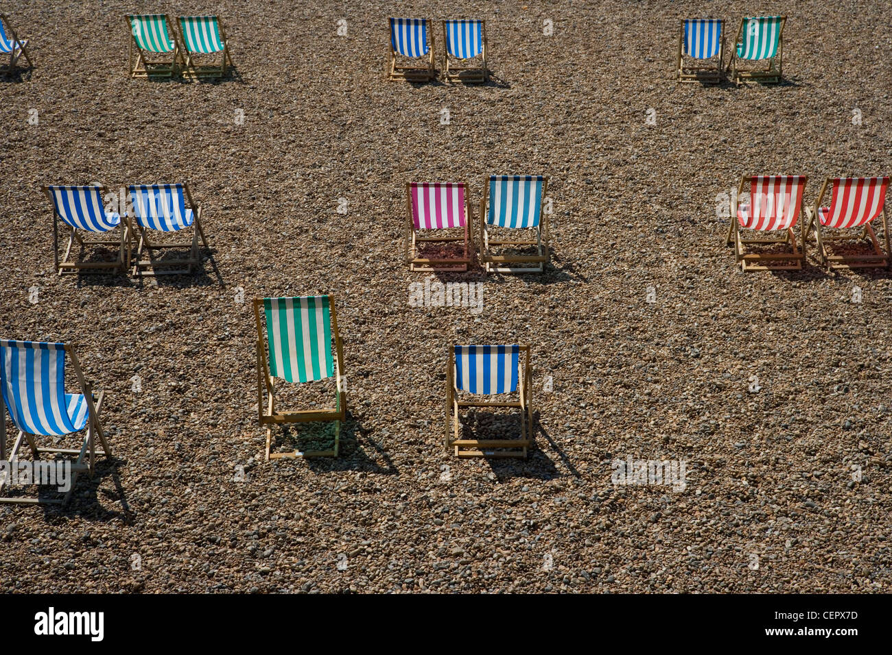 Colourful stripy deckchairs on Brighton beach. Stock Photo