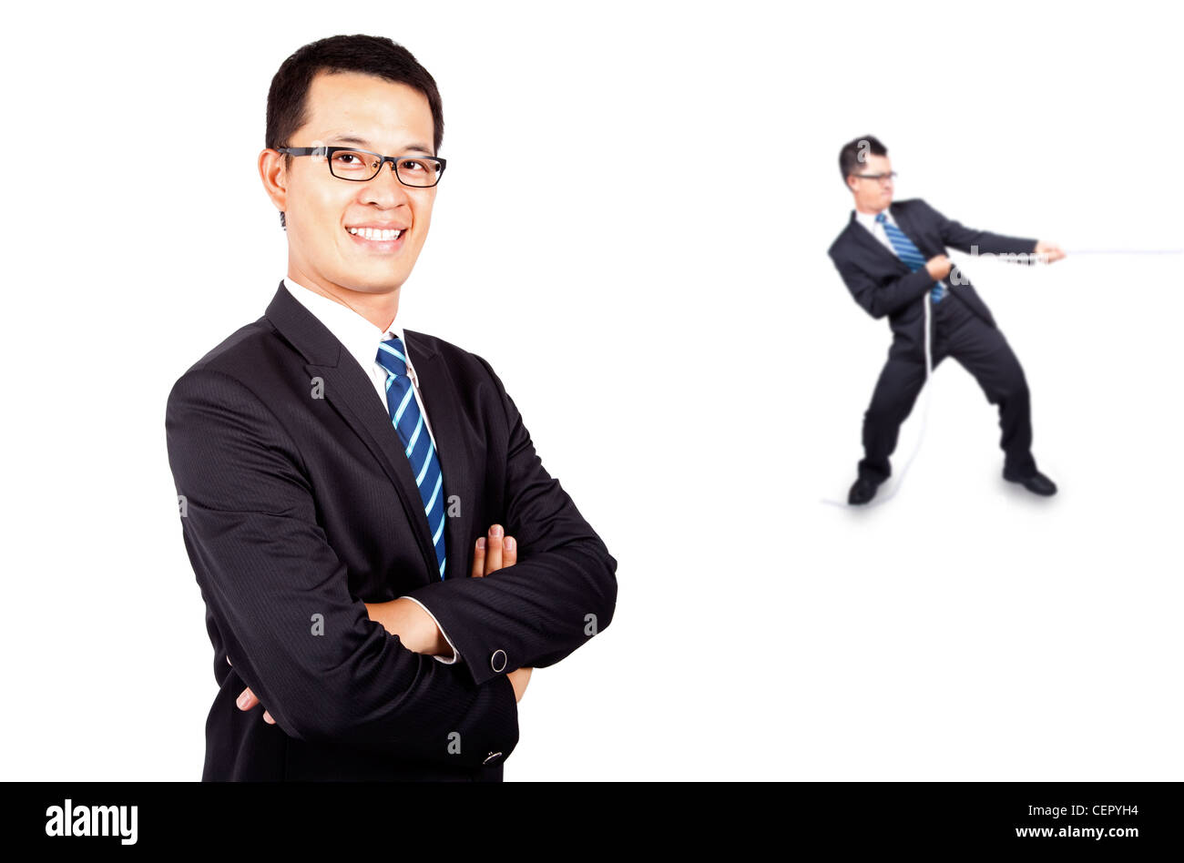 business man playing tug of war with himself Stock Photo - Alamy