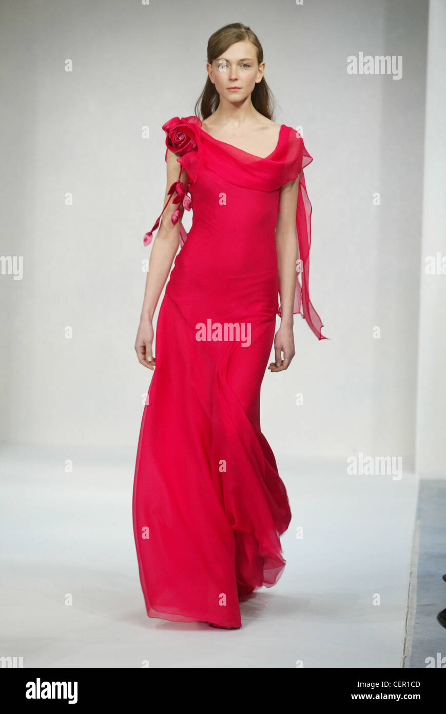 Luisa Beccaria Milan Autumn Winter Model brunette hair off face wearing  sleeveless flolength red dress fabric flower detail Stock Photo - Alamy