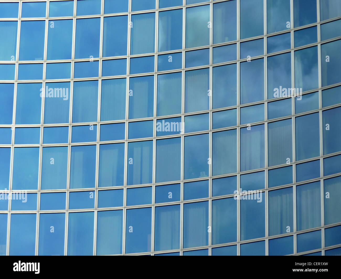 Close up of the facade of a modern business building with lots of blue ...