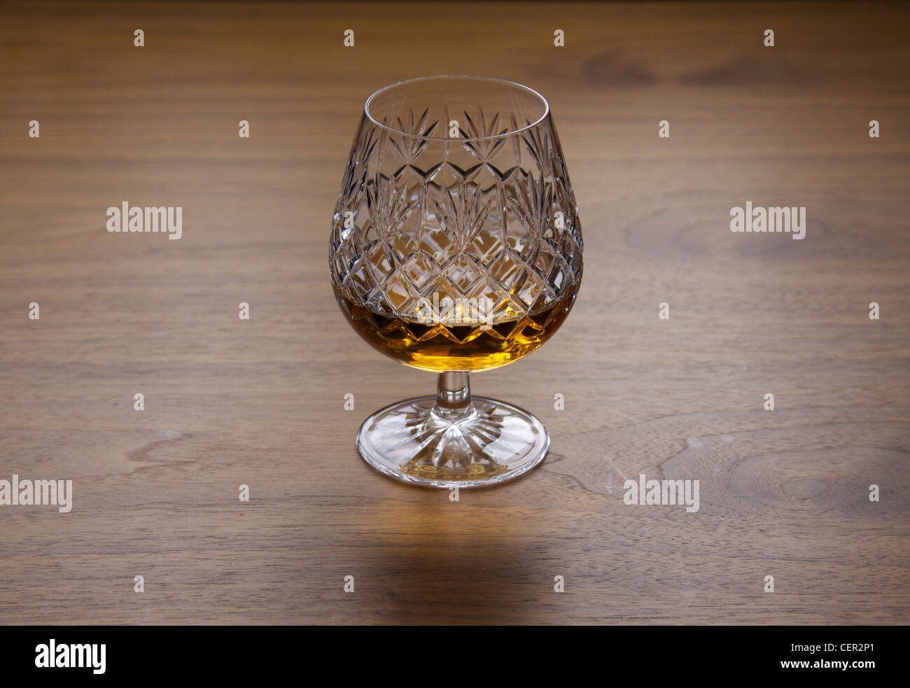 Traditional brandy glass made from cut crystal with brandy or whiskey