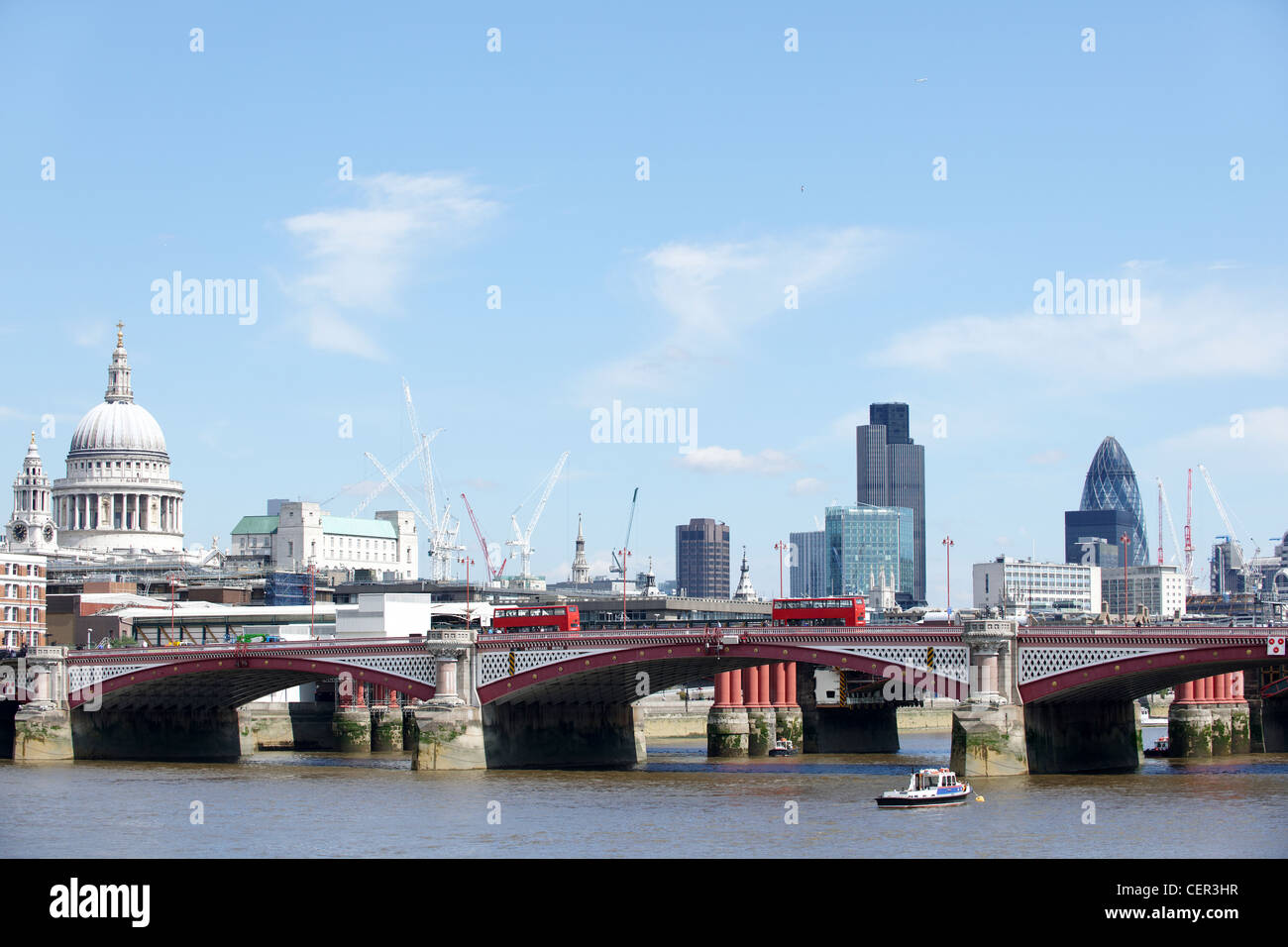 View of Blackfriars Bridge with a red bus and the City of London providing the backdrop. Stock Photo
