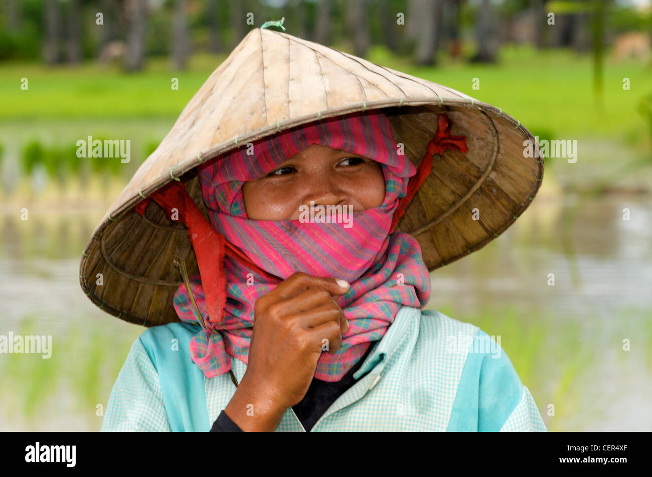 Portrait of Khmer woman wearing a krama (traditional Cambodian scarf) & conical hat, Kampong Thom Province, Cambodia. credit: Kraig Lieb Stock Photo