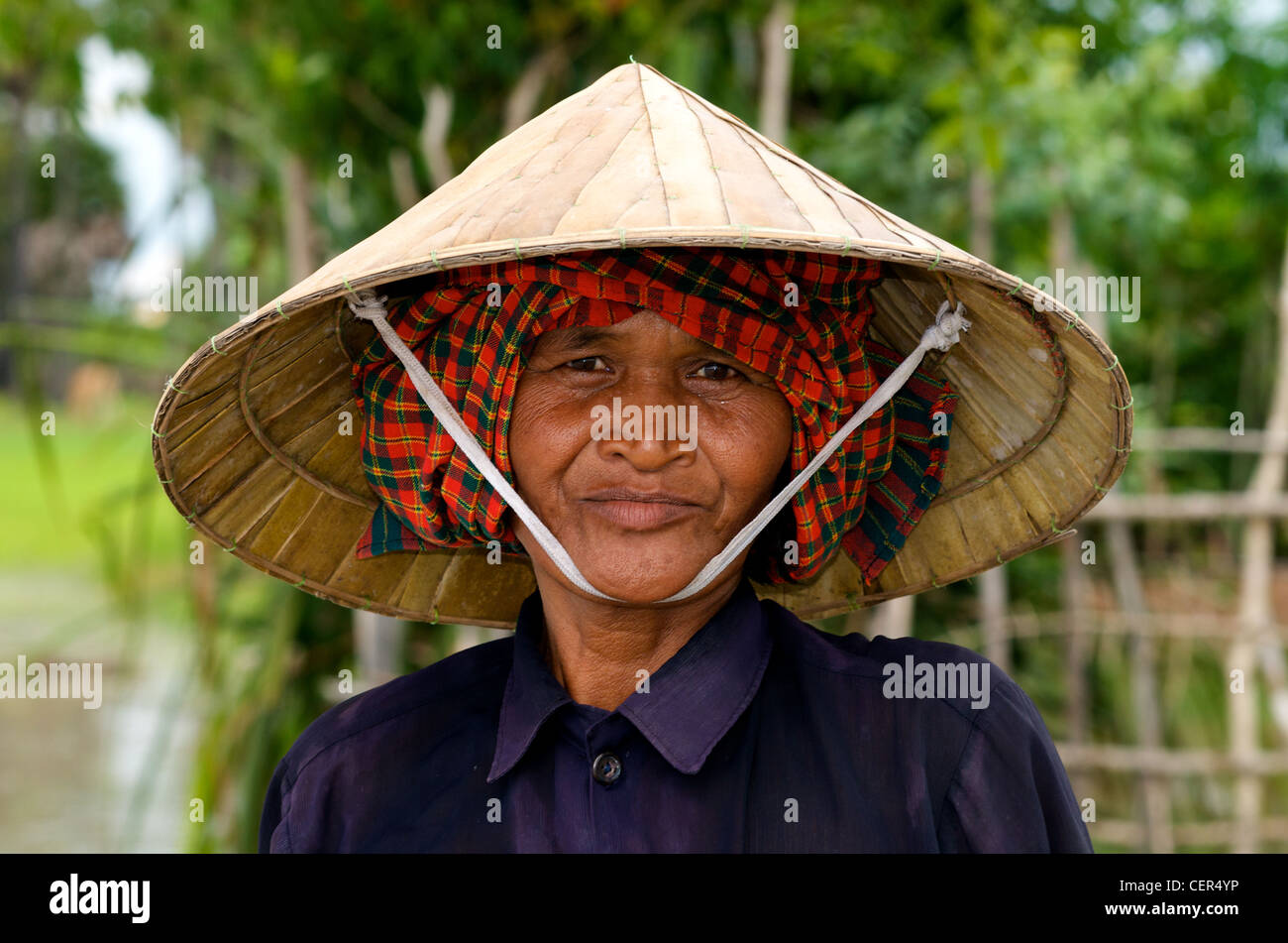 Portrait of a Khmer woman farmer wearing a krama (traditional Cambodian scarf) & conical hat, Kampong Thom Province, Cambodia. © Kraig Lieb Stock Photo