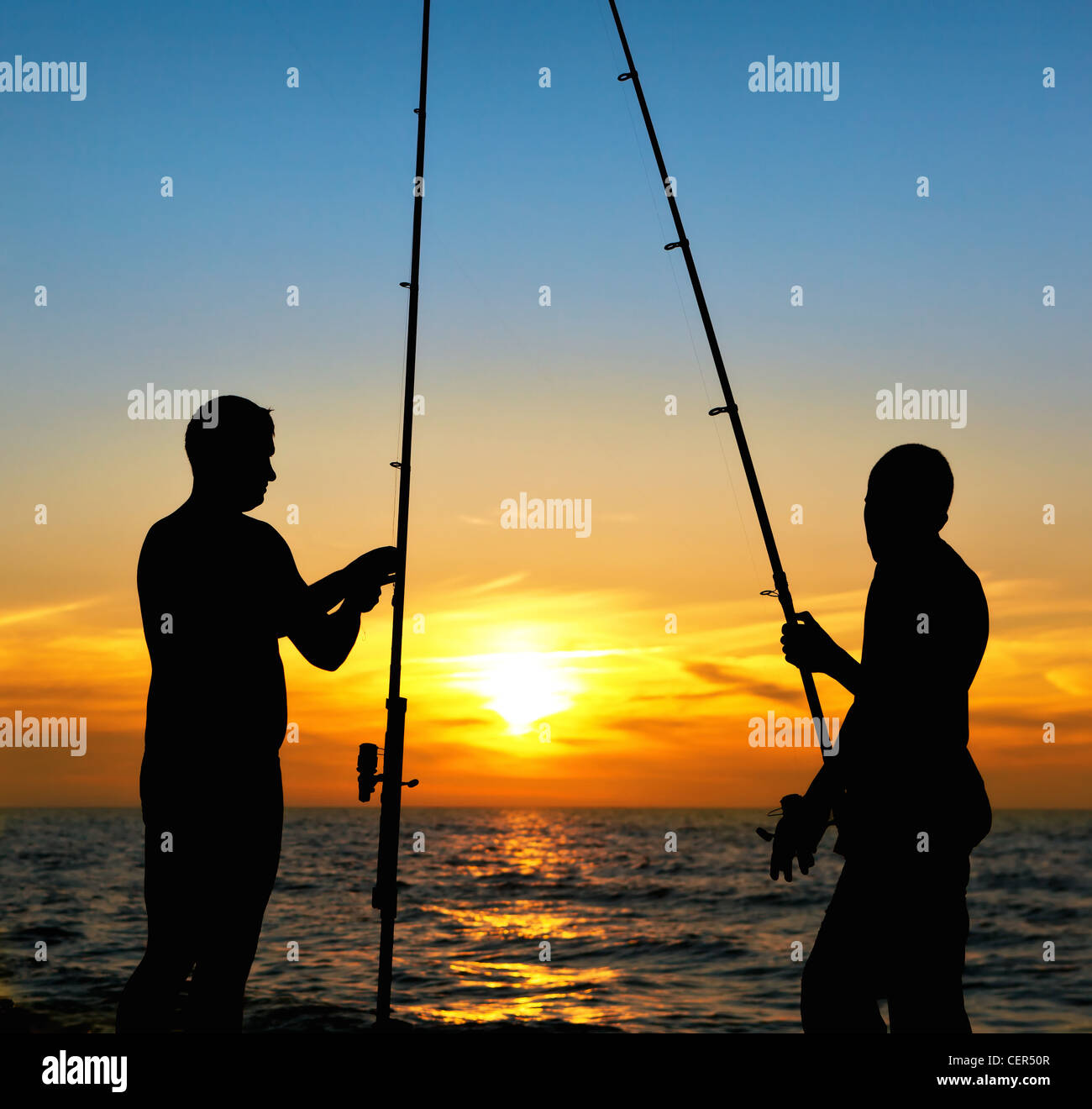 Silhouette of father and son fishing at sunset Stock Photo - Alamy