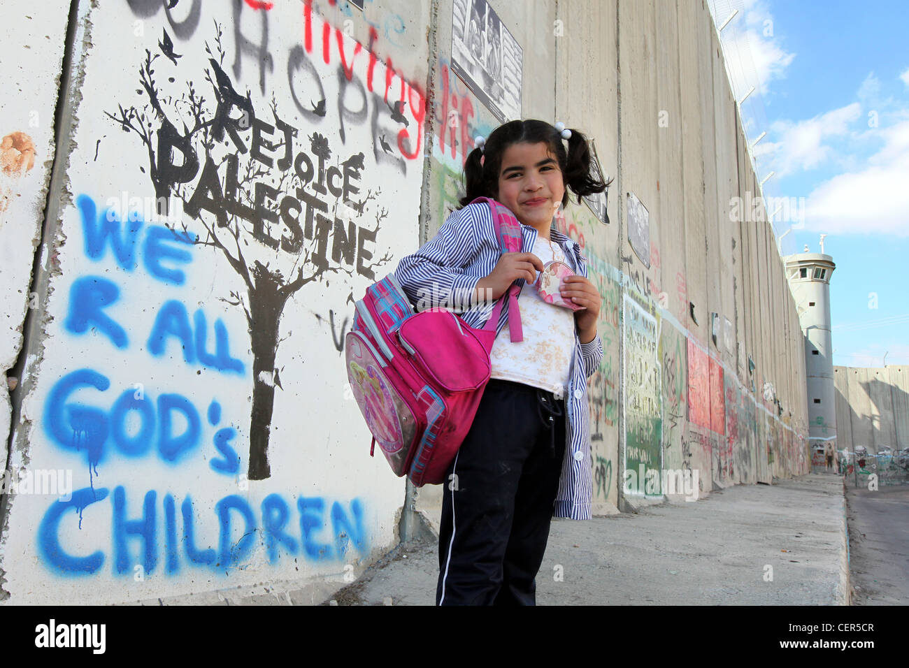 Girl standing at the Israeli separation wall. This wall divides Palestinian lands in the West Bank near the Bethlehem checkpoint Stock Photo