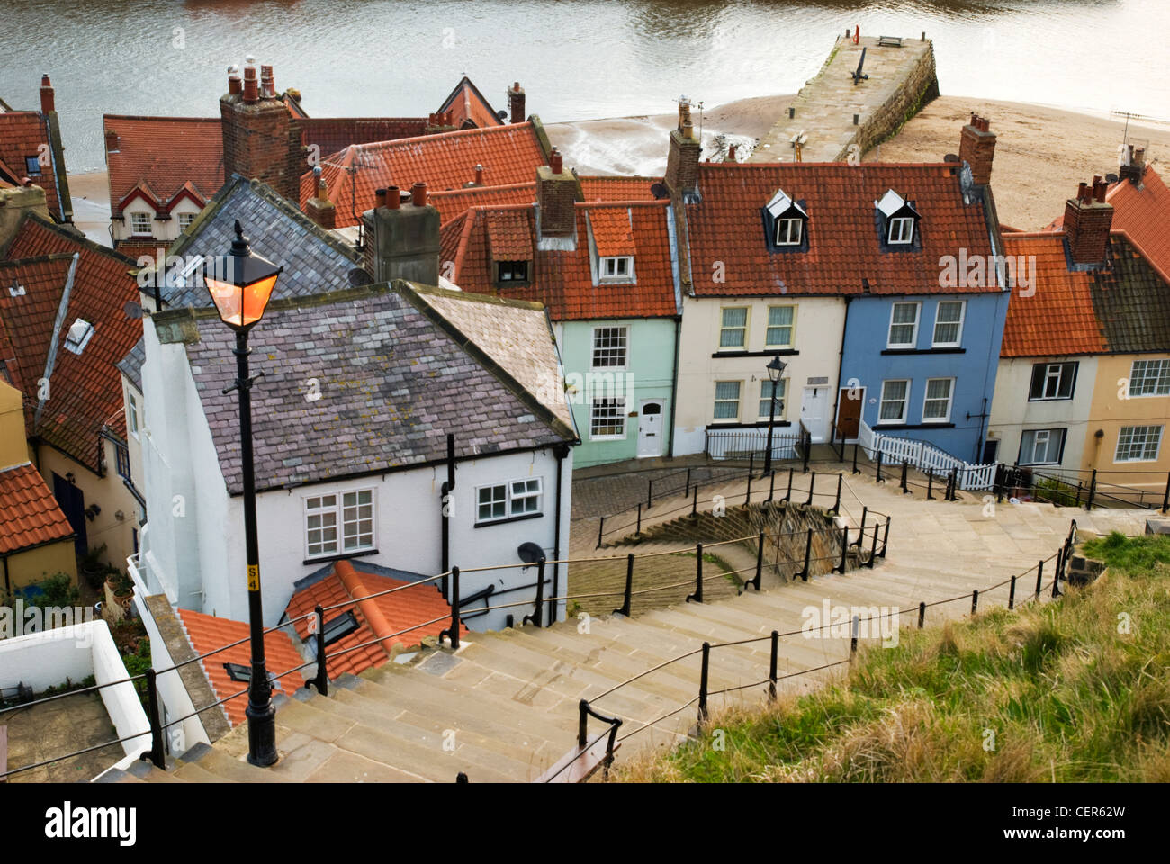 A traditional street light illuminates the 199 steps leading down towards the old town of Whitby. Stock Photo