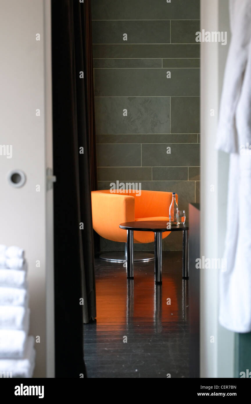 An orange chair viewed through a doorway at West Street Hotel. Stock Photo