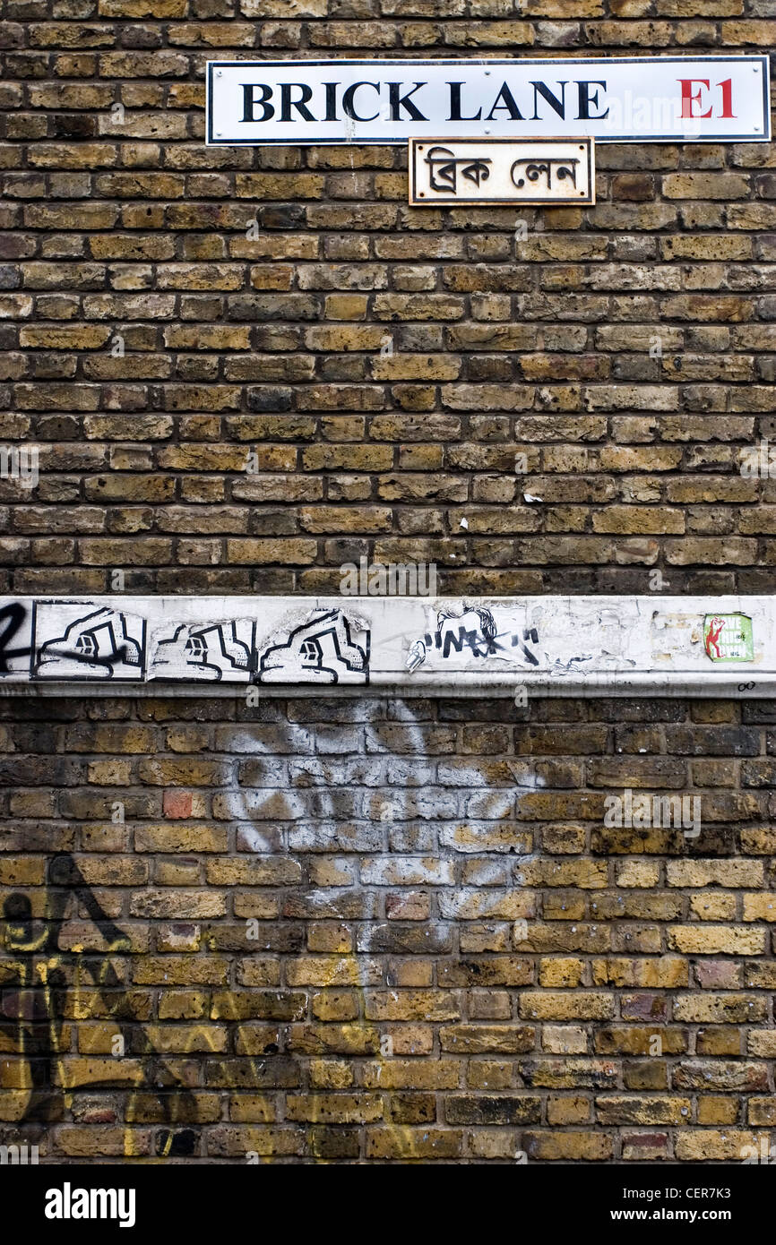 Brick Lane sign and graffiti. This area, often referred to as Banglatown, is home to the city's Bangladeshi community and a popu Stock Photo