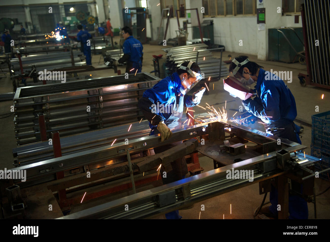 Employees make security doors in a factory of Wang Li Group,   in Yongkang, Zhejiang, China. 08-Nov-2011 Stock Photo