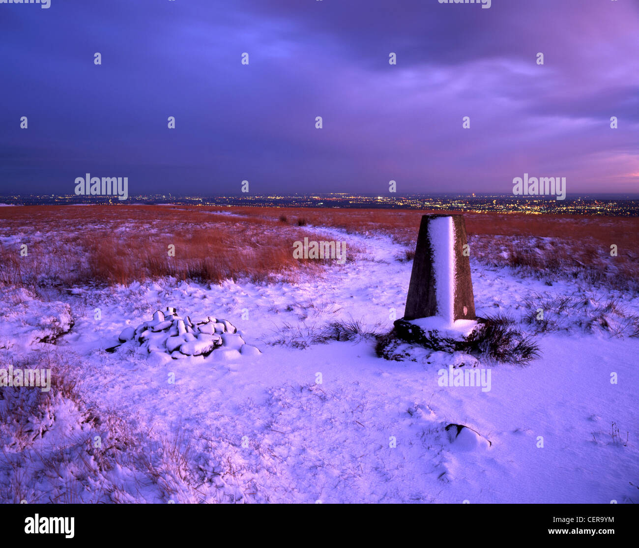 The trig point on Cheetham Close (329m) offers good views of the lights of Bolton at dusk. A trig point is a fixed station for s Stock Photo