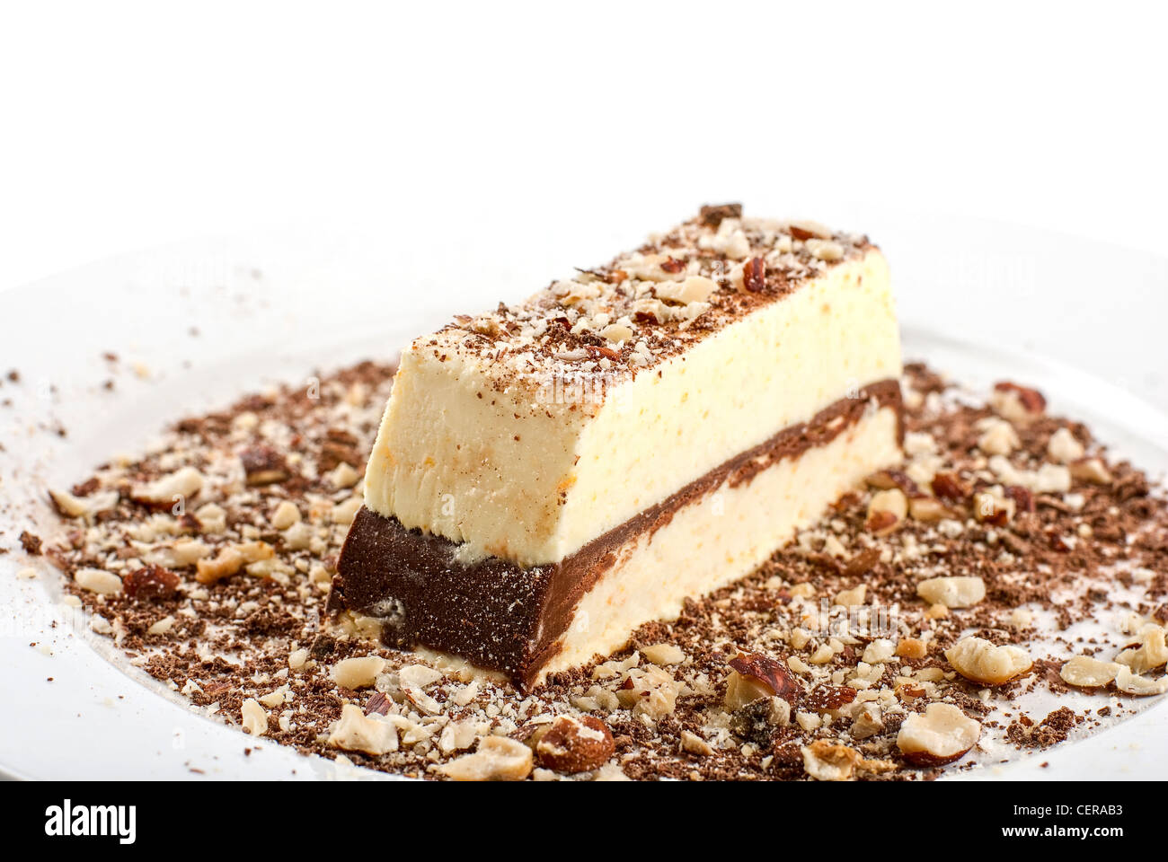 Slice of chocolate cake with nuts isolated on white Stock Photo - Alamy