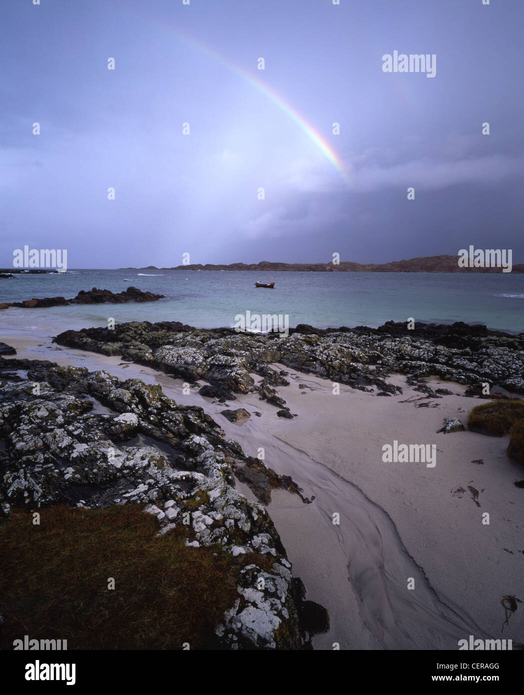 A double rainbow above Mull. The picture was taken from near the jetty on Iona. Stock Photo