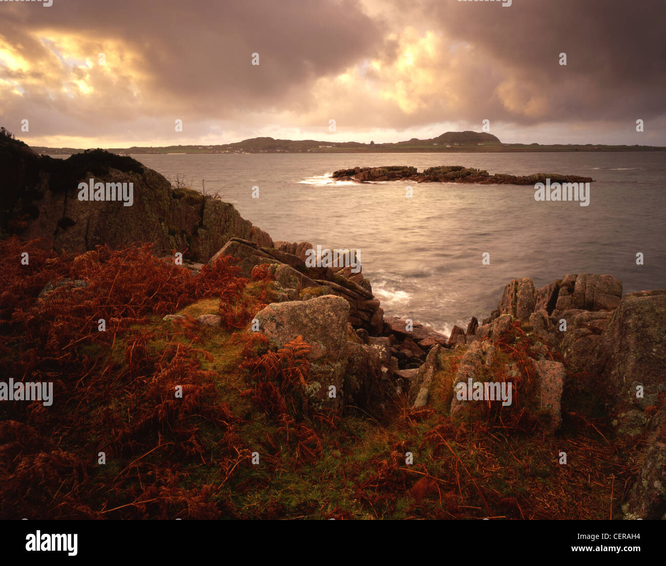 Iona and its famous abbey can be seen from the rugged coastline near Fionnphort. Now restored, the Iona Abbey was originally a m Stock Photo