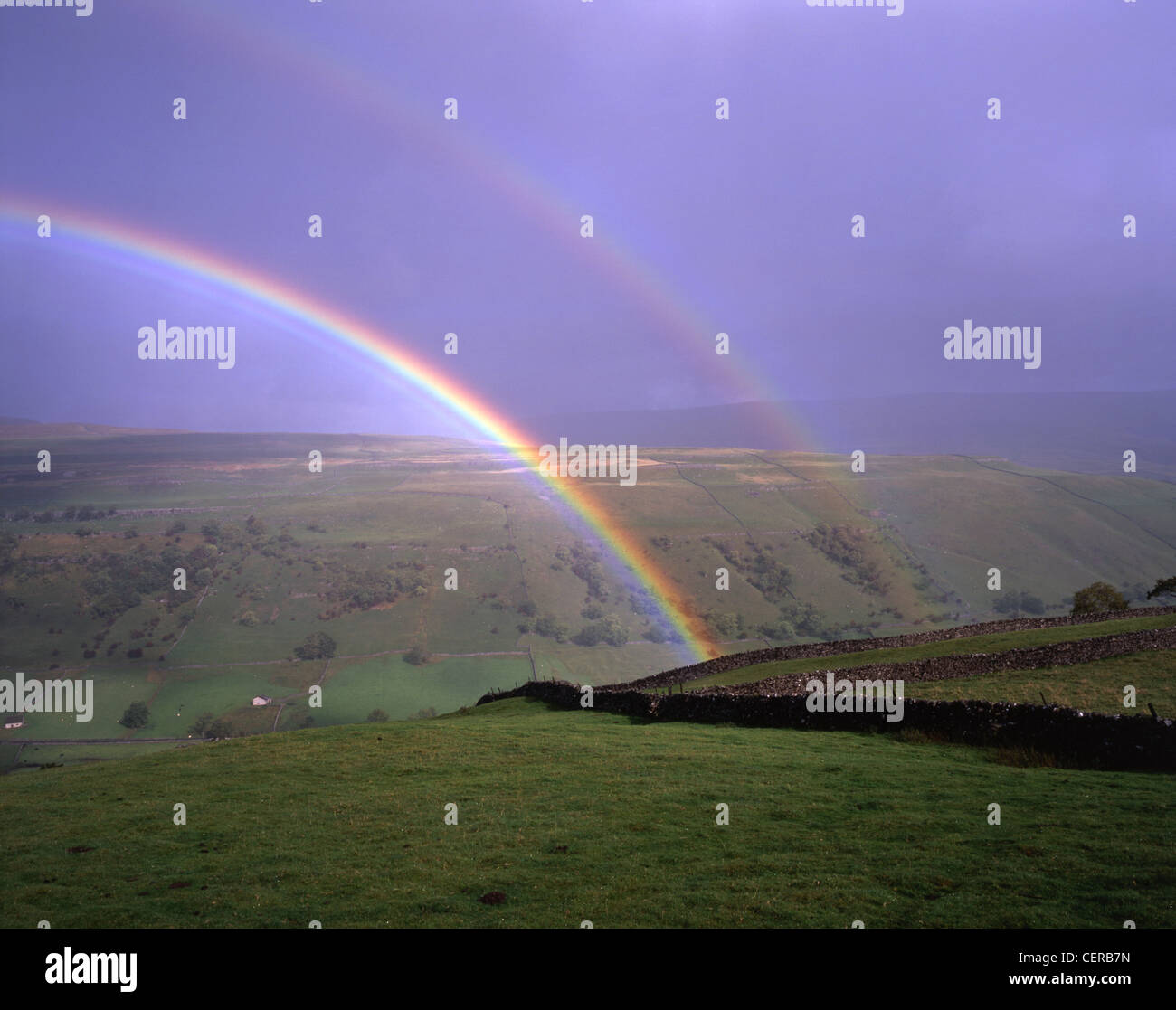 A double rainbow over Wharfedale near Kettlewell in the Yorkshire Dales National Park. The remains of the smelting-mill, used fr Stock Photo