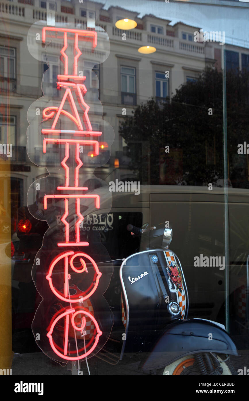 Red neon sign in Tattoo studio, shop window, Lisbon, Portugal Stock Photo