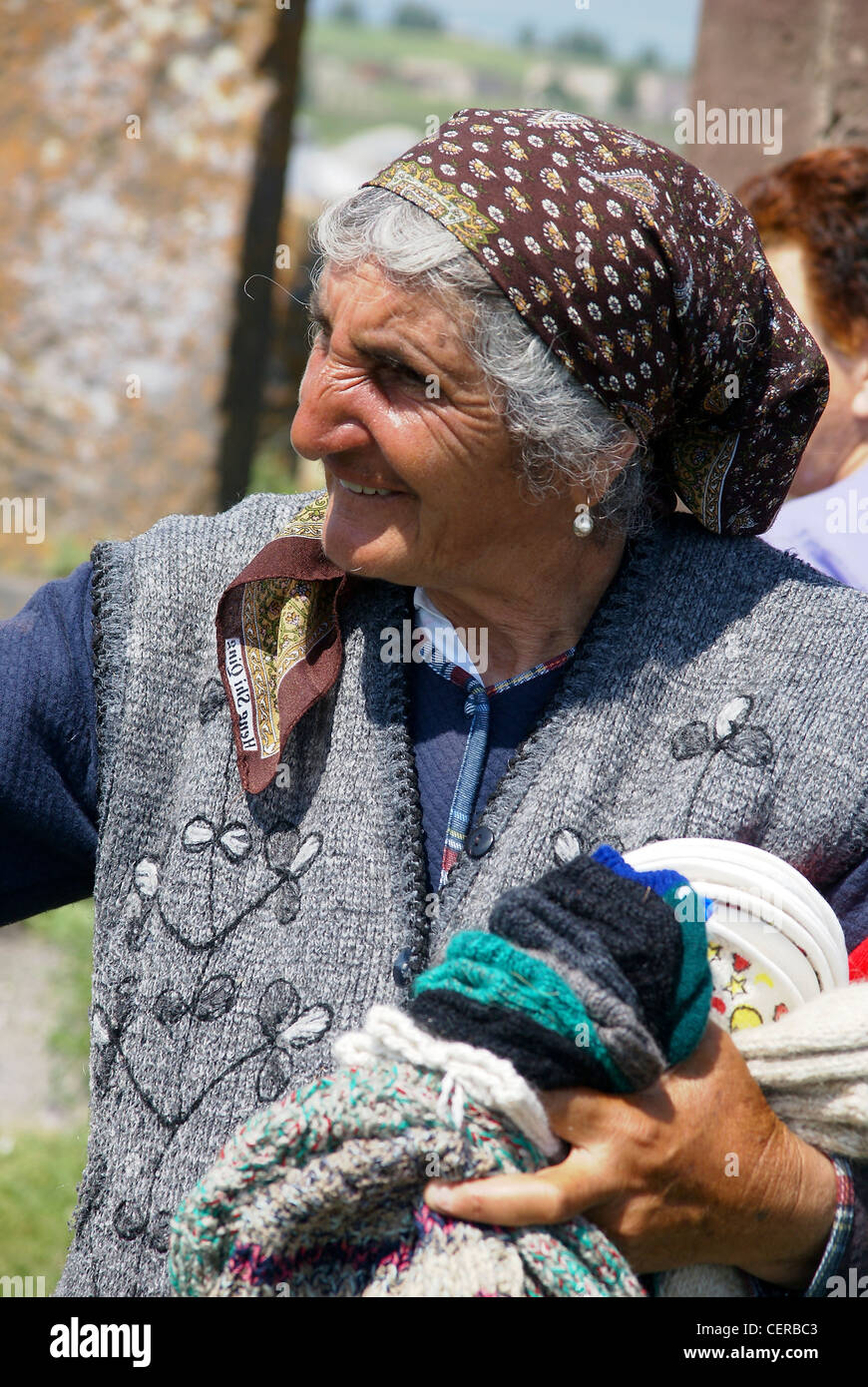Armenia, Lake Sevan, Noraduz cemetery Local woman sells souvenirs to tourists Stock Photo