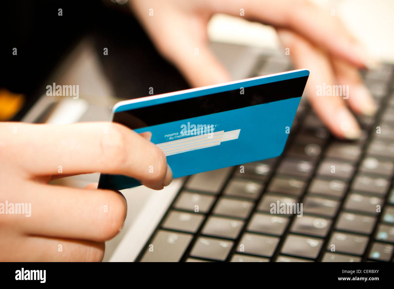 Hands entering credit card information into a laptop Stock Photo