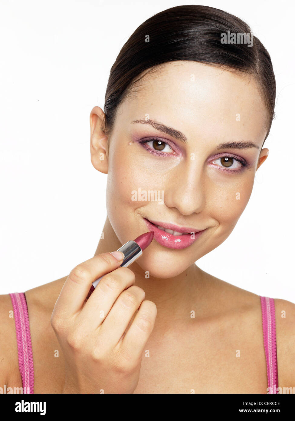 Brunette Female With Hair Worn Back Wearing Pink Eyeshadow And Applying