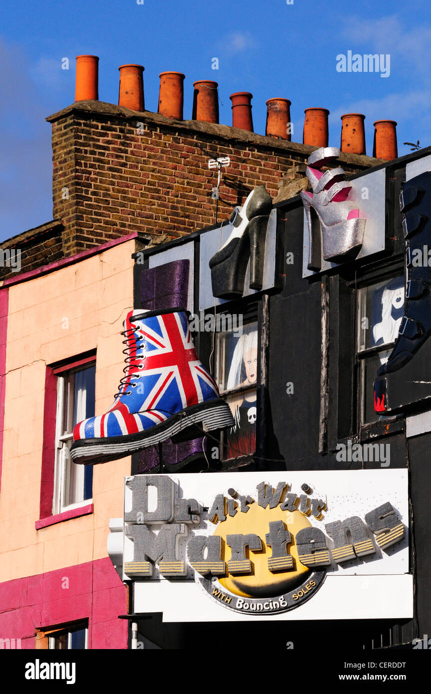 Large models of shoes hanging above a shoe shop in Camden High Street. Stock Photo