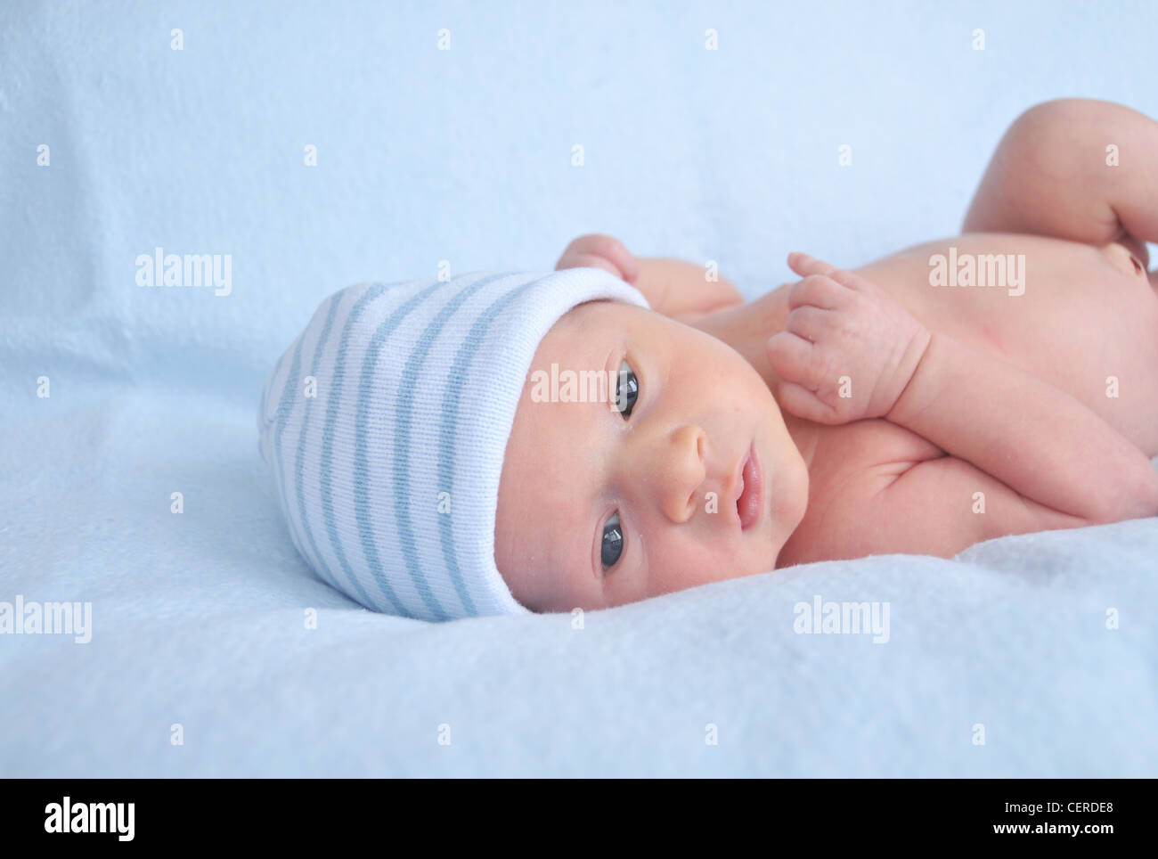 Newborn baby boy in a blue hat Stock Photo - Alamy