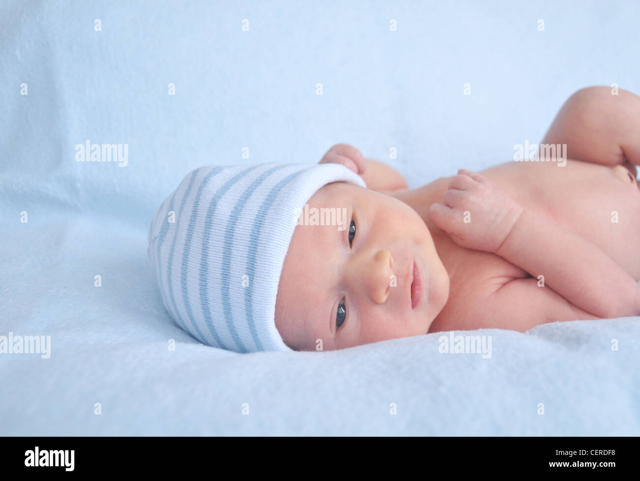 Newborn baby boy in a blue hat Stock Photo - Alamy